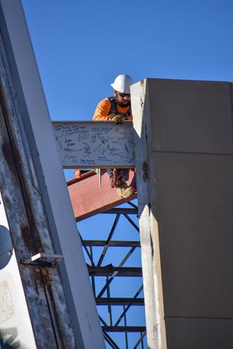 Worker installs the Signed beam